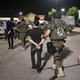Members of the St. Louis County Police tactical team take two journalists into custody on Aug. 19, 2014. Lukas Hermsmeier, left, a reporter for Bild, a German newspaper, and Ryan Devereaux, a reporter for theintercept.com, were in the area when police arrived.
David Carson/St. Louis Post-Dispatch